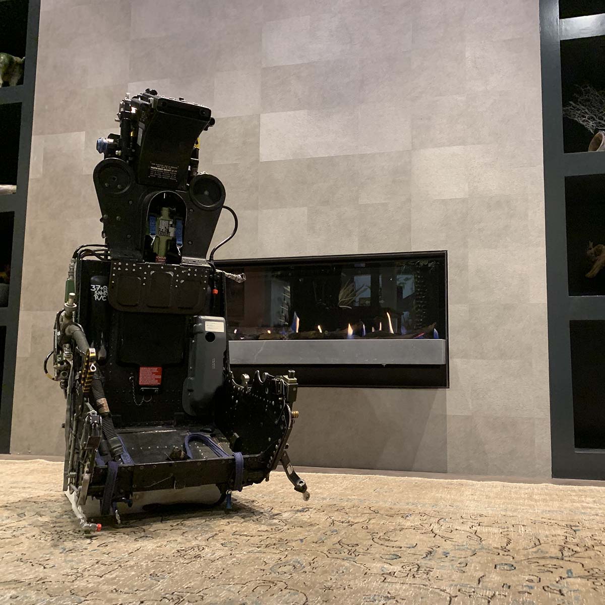 A Martin Baker ejection seat in front of a fireplace.