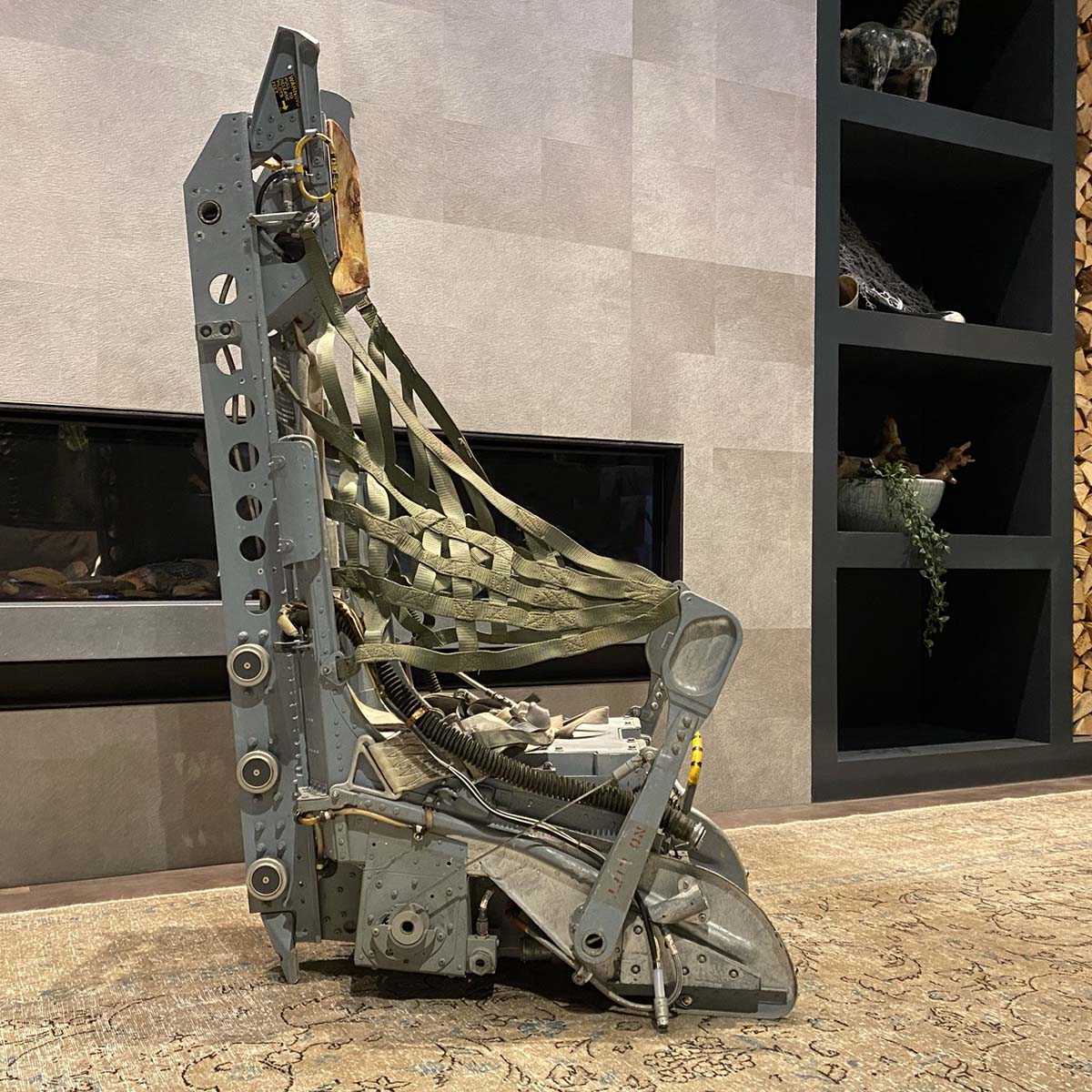 Lockheed Ejection seat in front of fireplace.