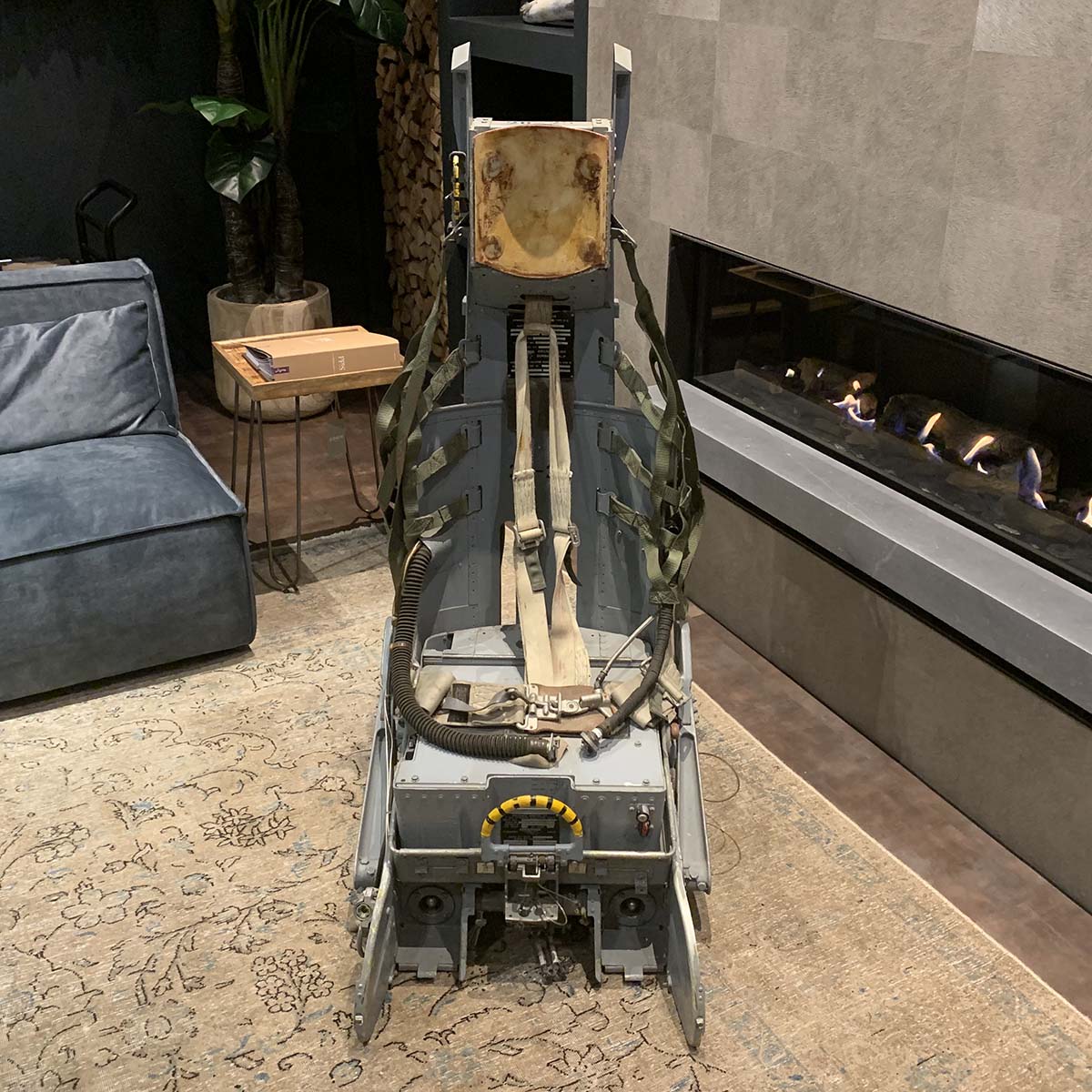 Lockheed Ejection seat in front of fireplace.