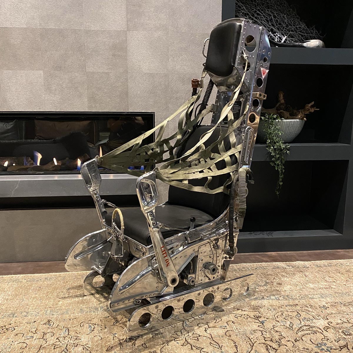 Polished Lockheed Martin ejection seat in a living room.