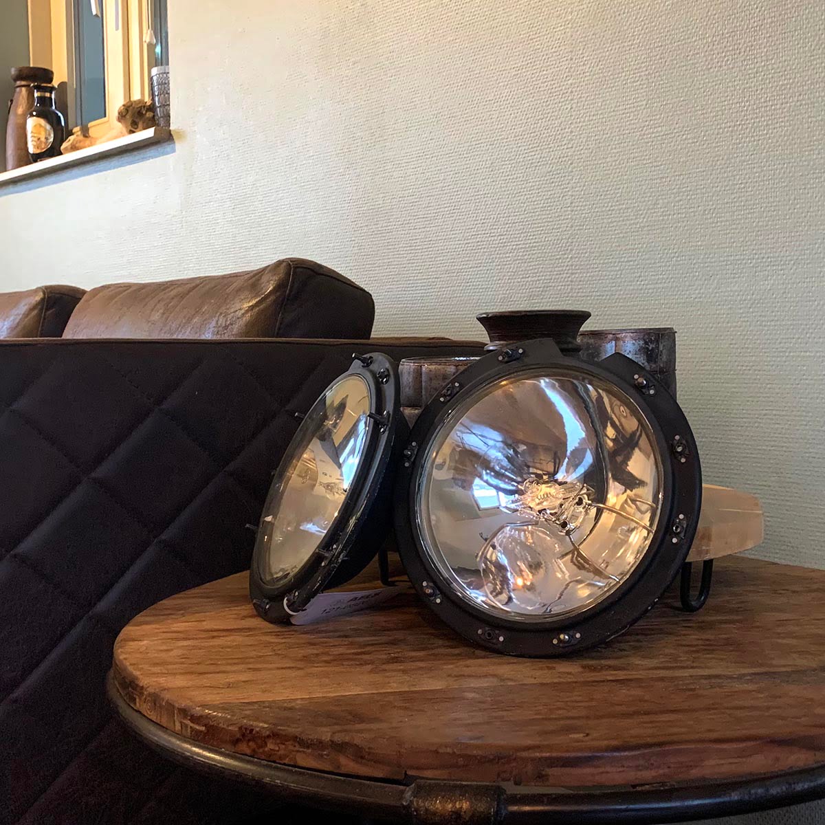 Two Boeing 747 landing lights on a table.