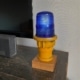 Yellow taxiway light fitted on an oak base.