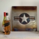 United States Air Force steel roundel artwork next to some bottles on a shelf.