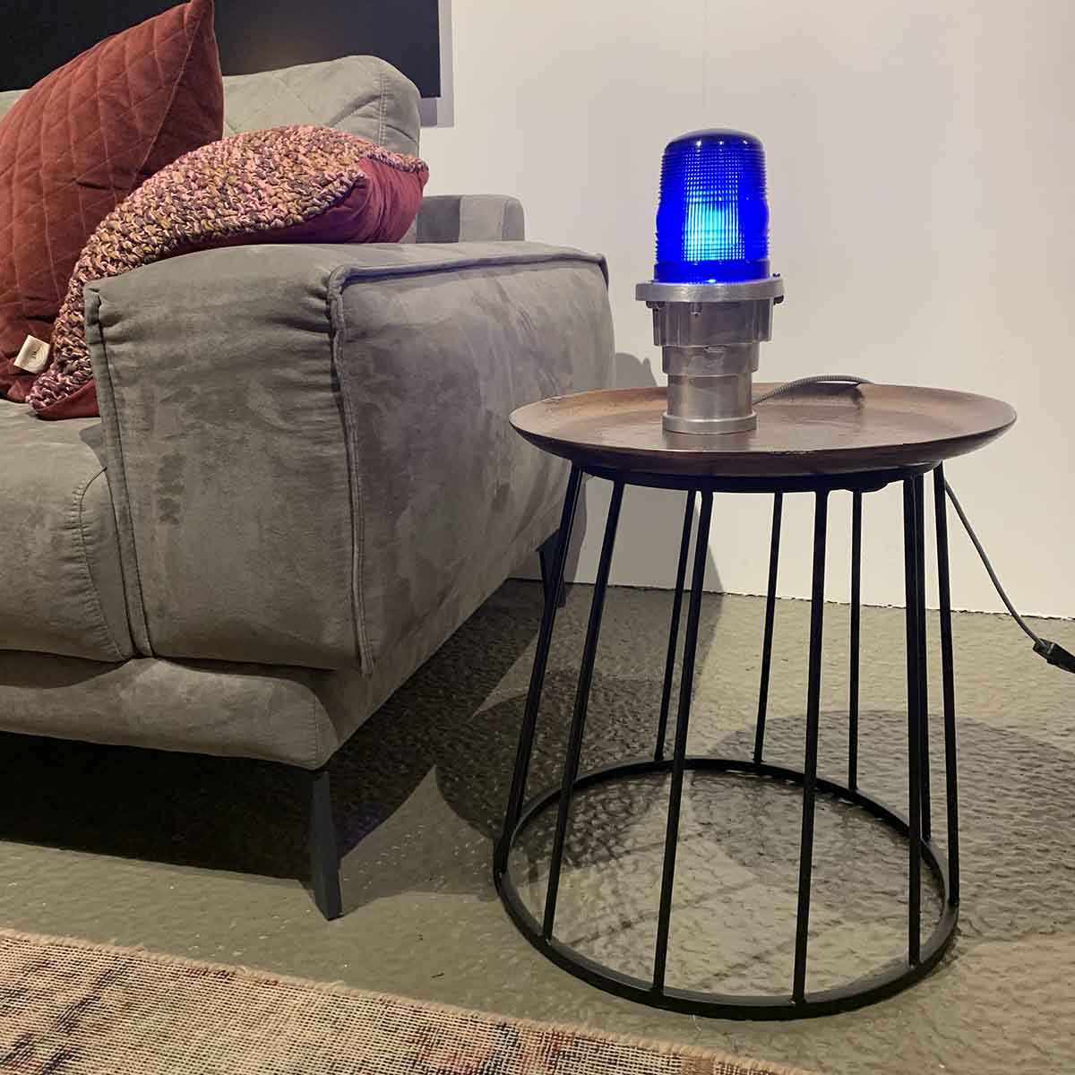 Stripped taxiway light on a side table.