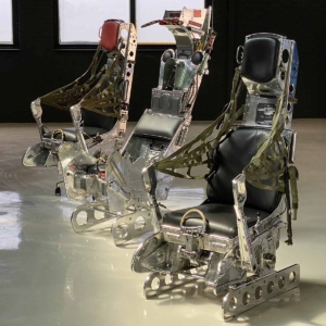 Line-up of three mirror polished ejection seats.