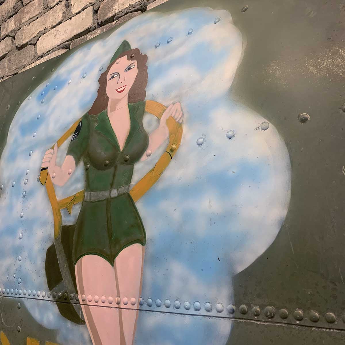 Detail of original C-47 Dakota skin panel painted with nose art of D-Day Doll.