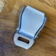 Detail of an aviation seatbelt keychain holder with keys.