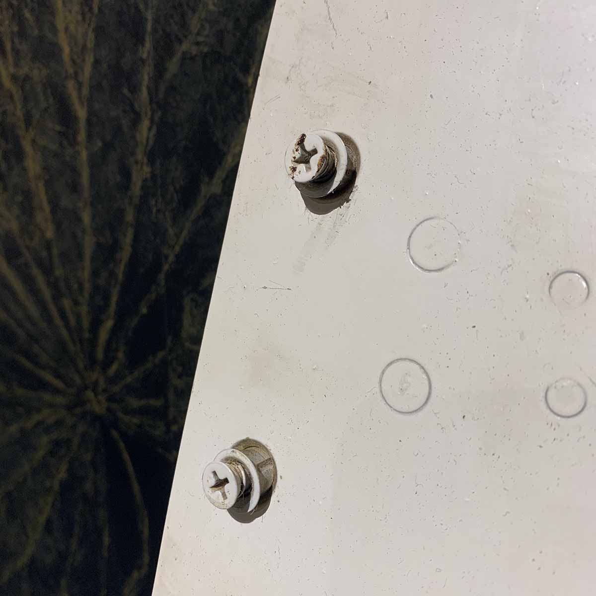 Detail of screws on access panel of a Vought F-8 Crusader.