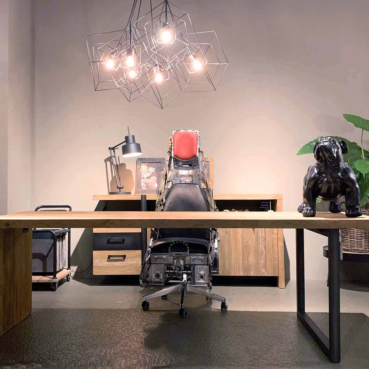 Office chair made of a polished Lockheed C2 ejection seat behind a desk.