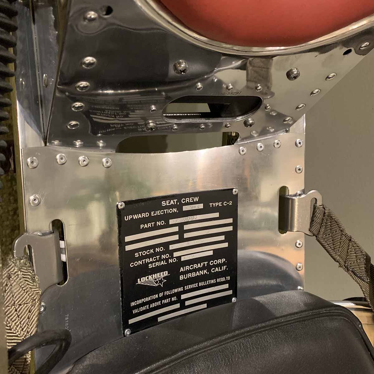 Identification plate on a polished Lockheed C2 ejection seat.