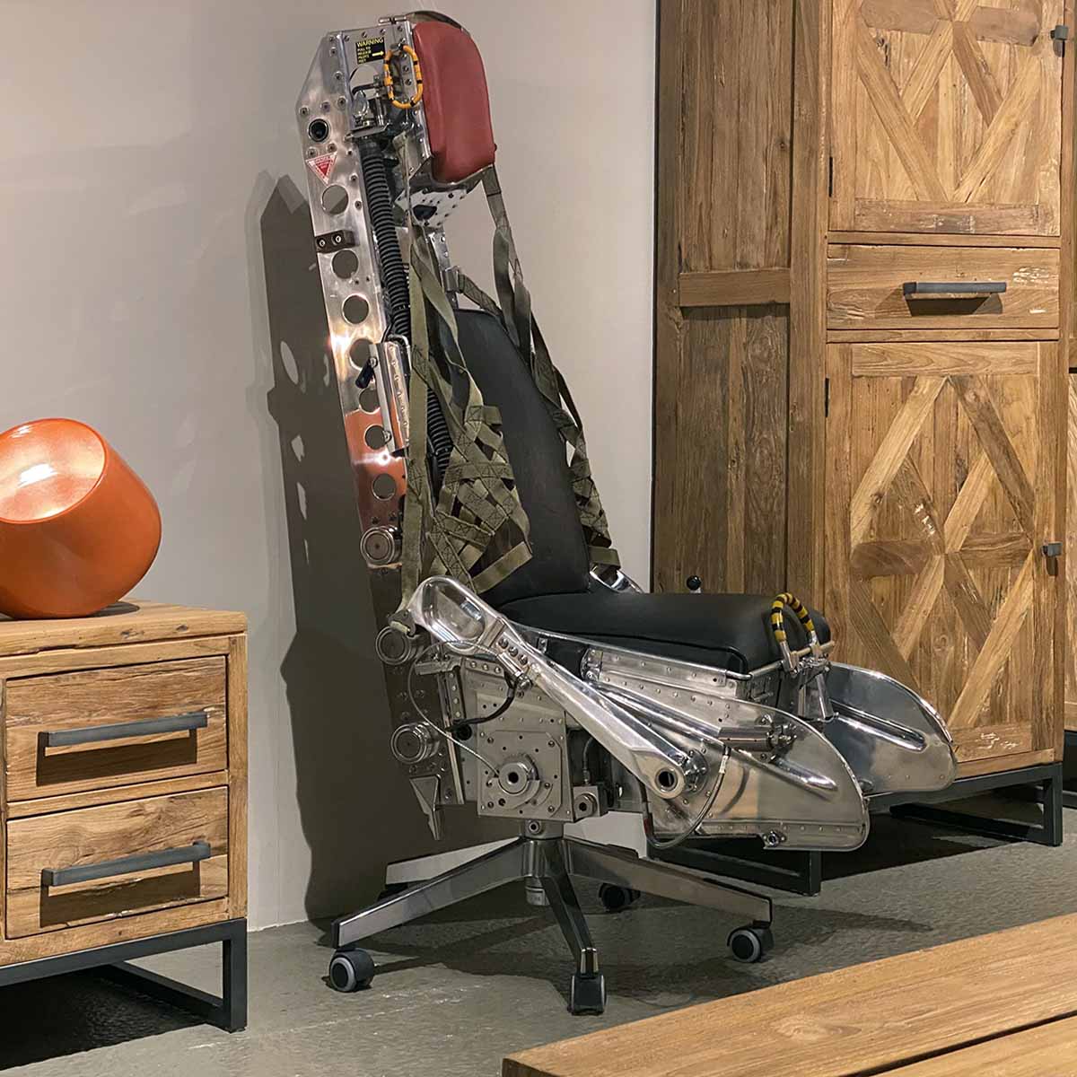 Office chair made of a polished Lockheed C2 ejection seat as a decorative piece.