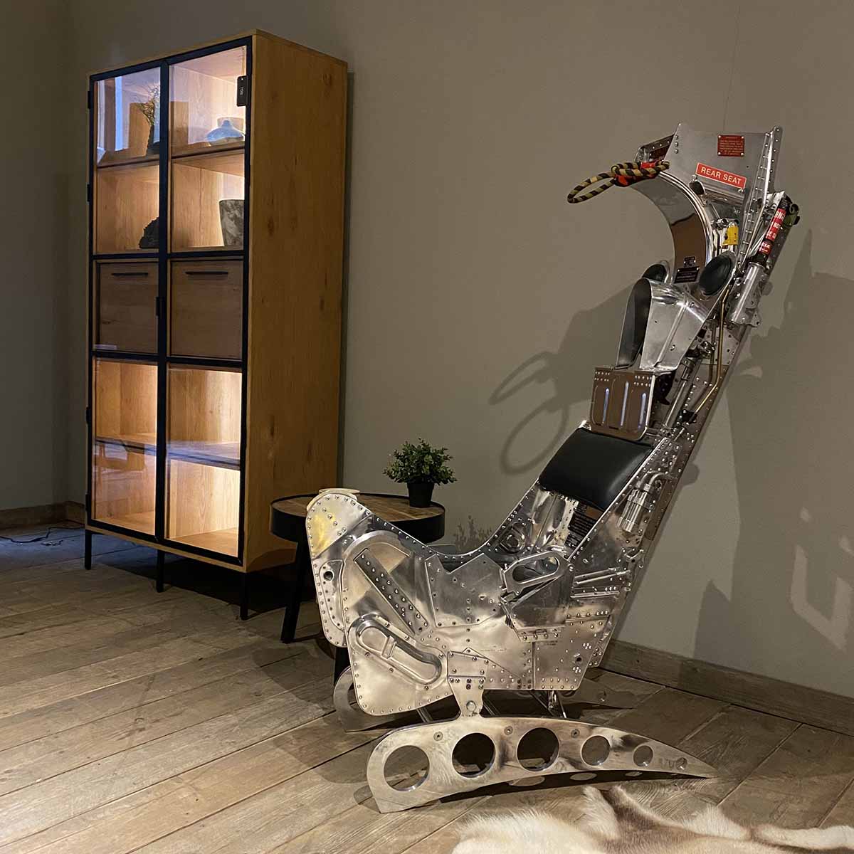 Mirror polished Martin-Baker Mk6 ejection seat in a living room.
