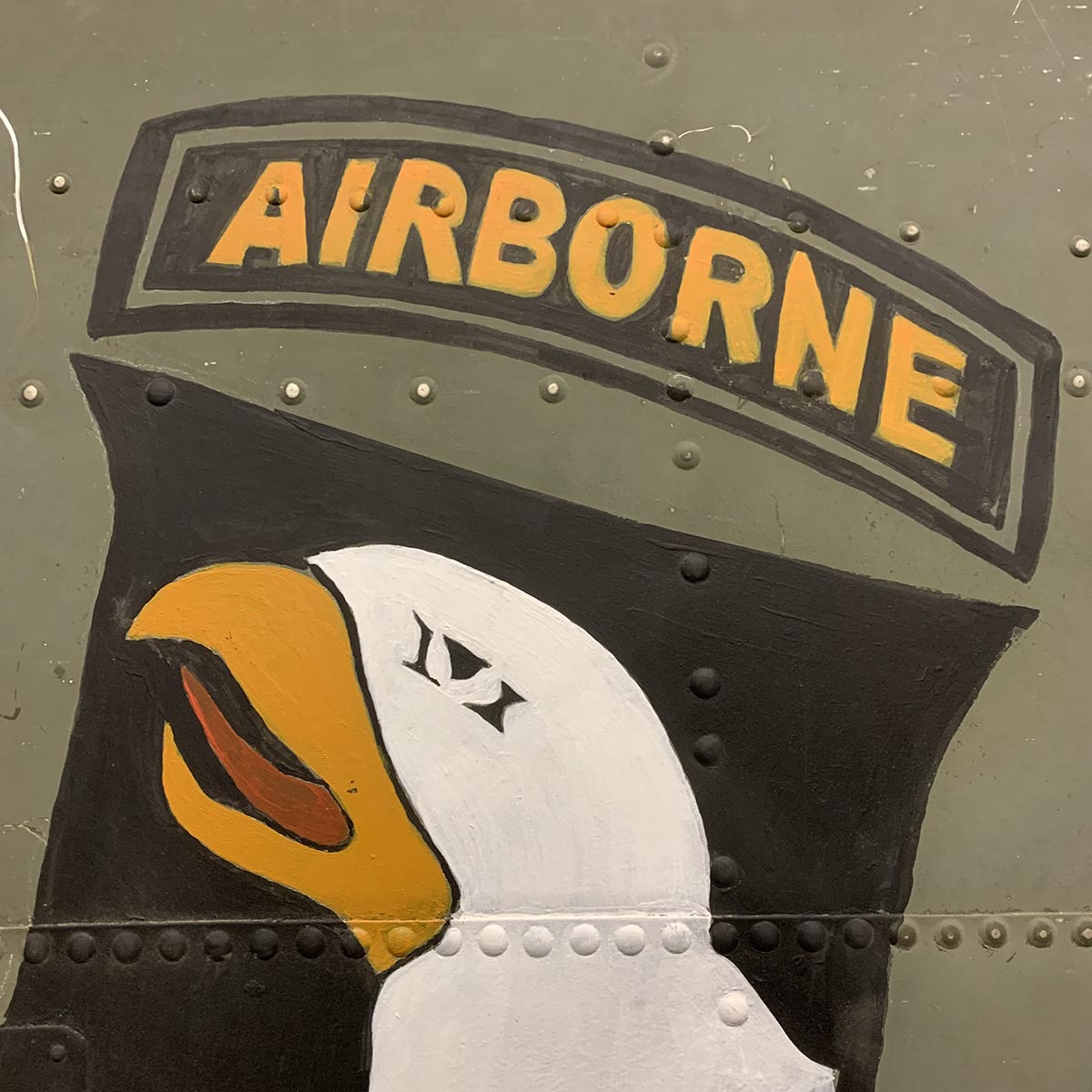 Detail of 101st Airborne Division nose art painted on an original C-47 Dakota skin panel.