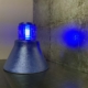 Refurbished Koninklijke Luchtmacht taxiway light with the blue light reflecting on the wall.
