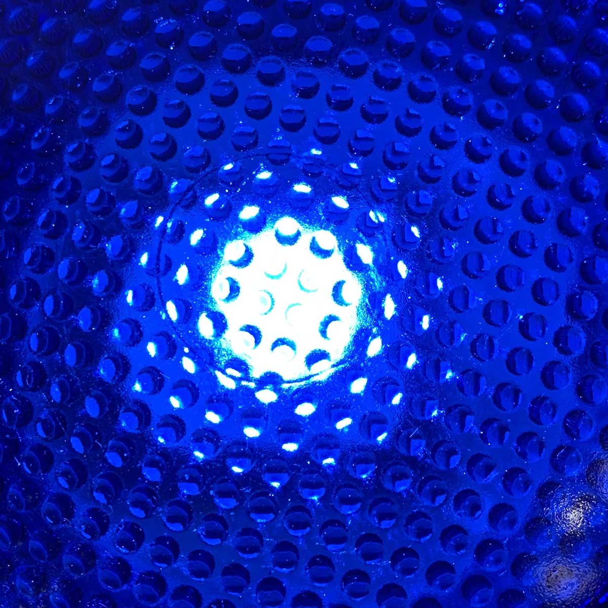 Close-up of the blue glass lens on a Thorn taxiway light.