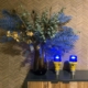 Two Thorn airport taxiway lights next to a vase on a cabinet in a living room.