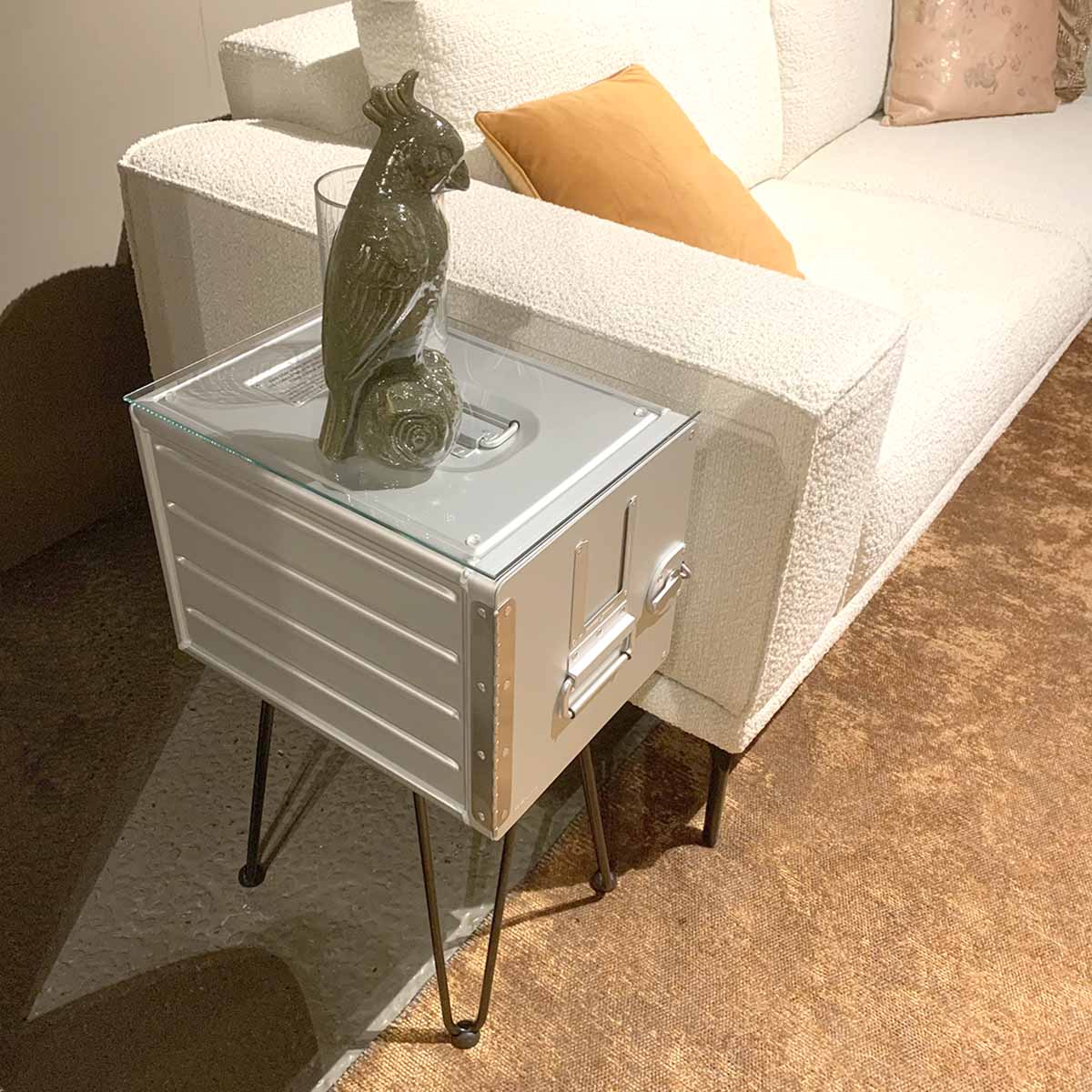 Aircraft galley container side table next to a white couch.