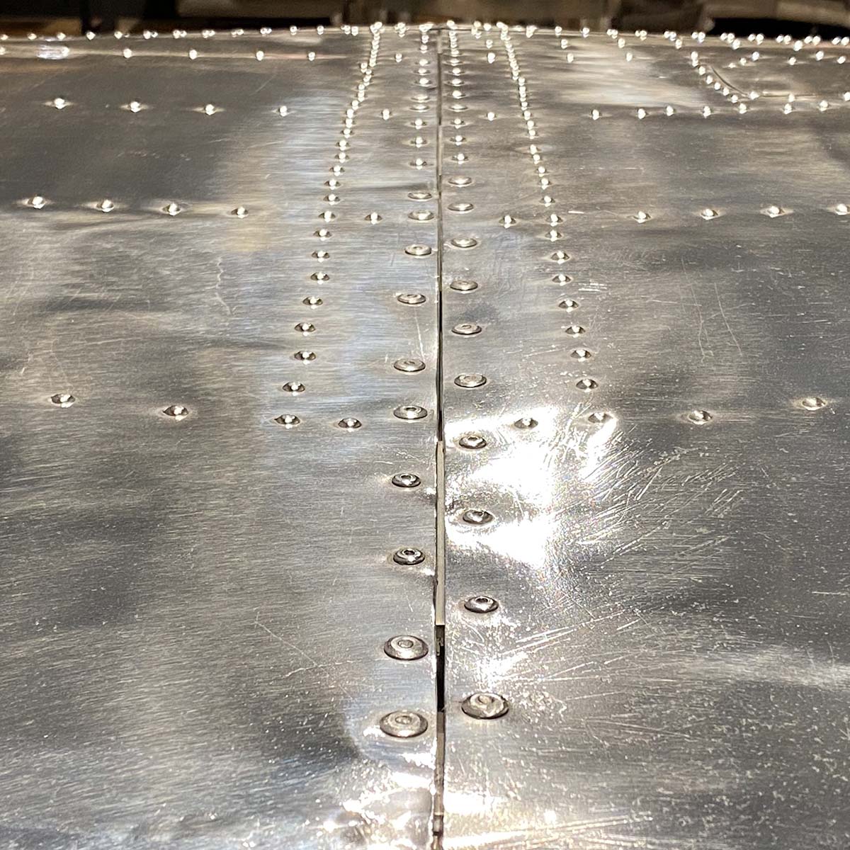 Details showing the rivets on a Beech 18 wingtip office desk.