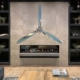 Polished Hartzell propellers and hub displayed above a fireplace in a modern living room.