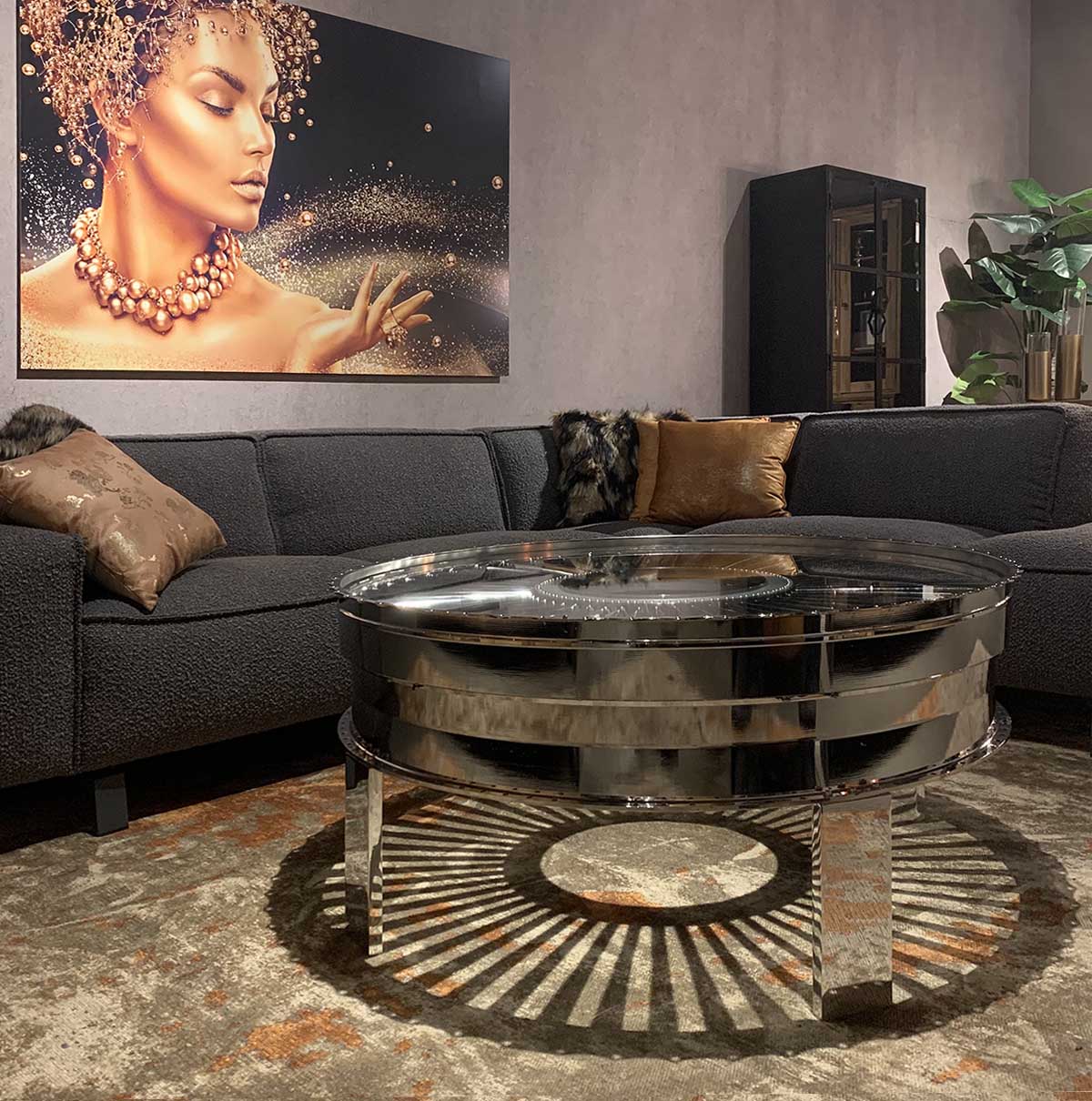 Polished rear fan case of a Pratt & Whitney JT8D in use as a table in a modern living room.