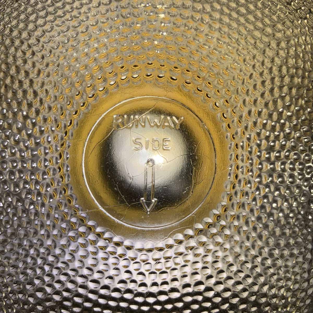 Top side of glass of a runway light with new LED-bulb.