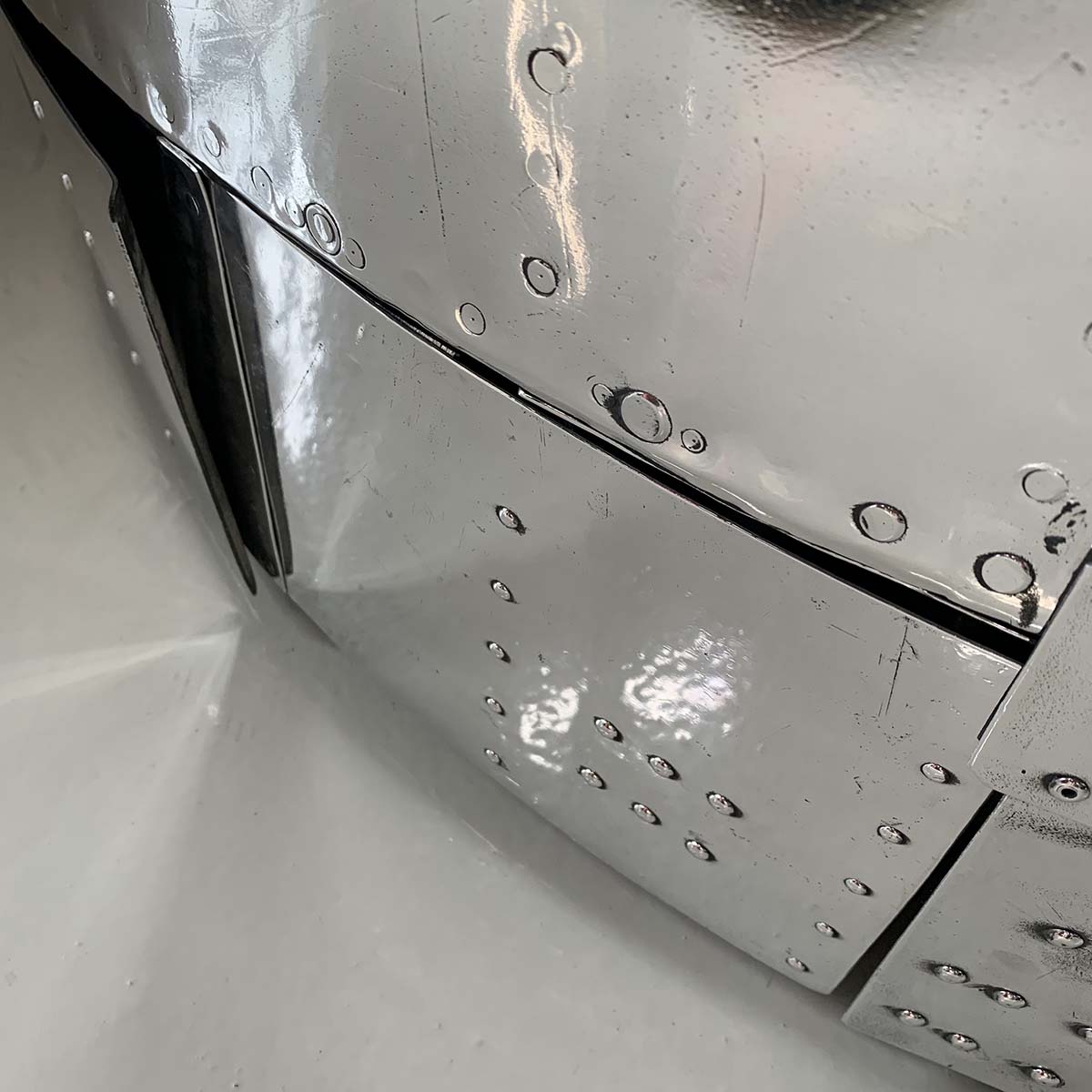 Detail of polished outside on a Douglas C-47 Dakota engine cowling love seat.