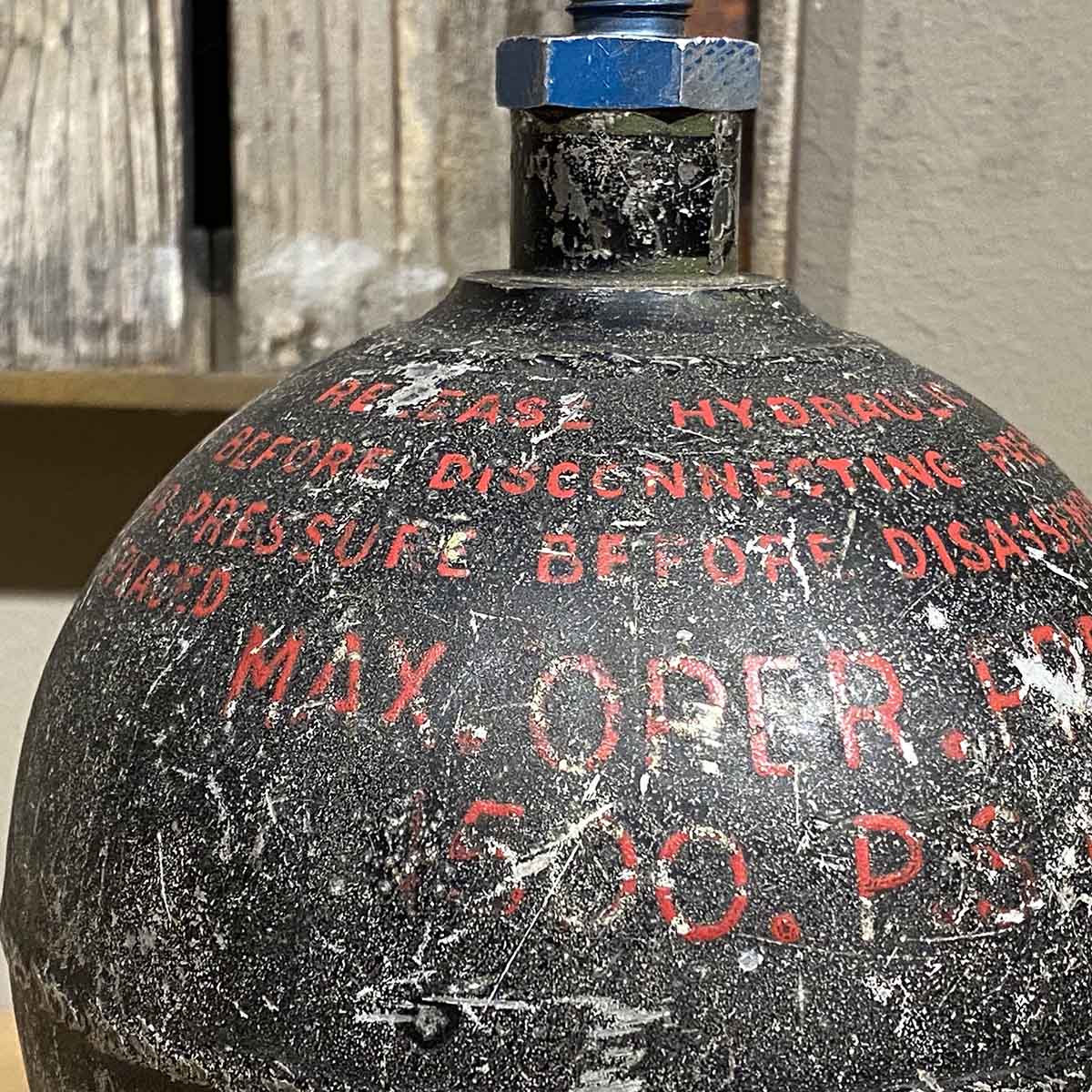 Detail of text on an aircraft hydraulic system accumulator.