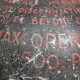 Detail of text on a hydraulic system accumulator from an aircraft.