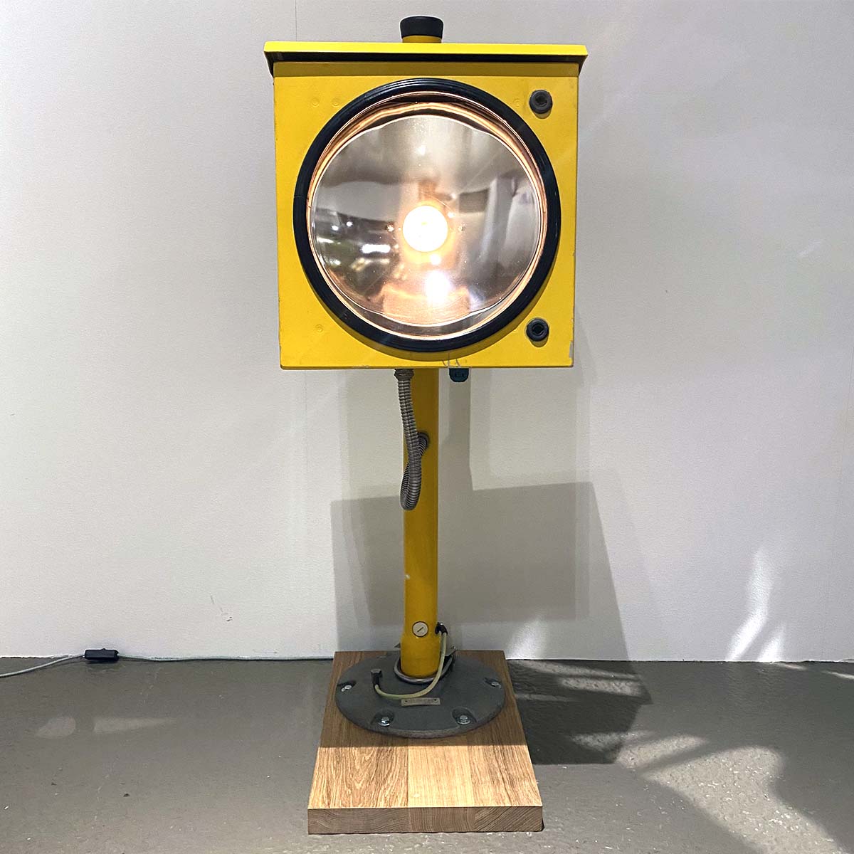 Front view of a Honeywell ASL-40 approach sequence flash light installed on an oak base as an interior light.