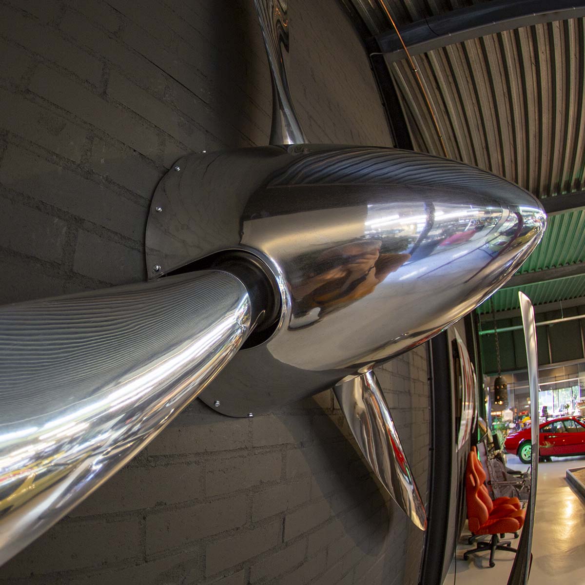 Side view of a polished three-bladed Hartzell propeller with spinner.