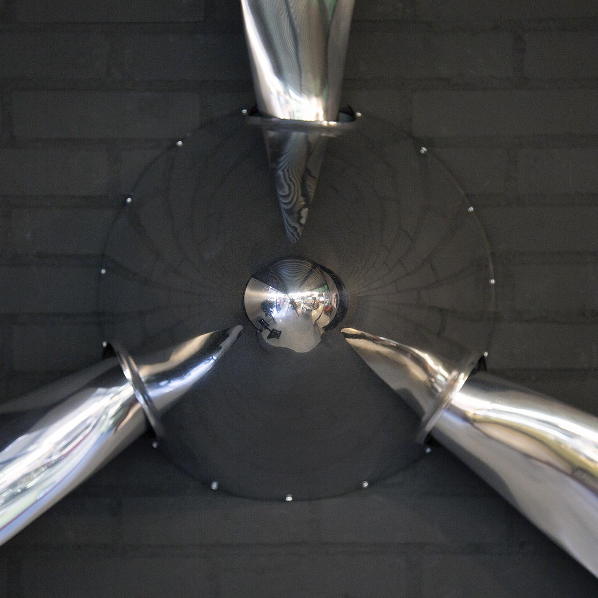Detail of the spinner on a polished three-bladed Hartzell propeller.