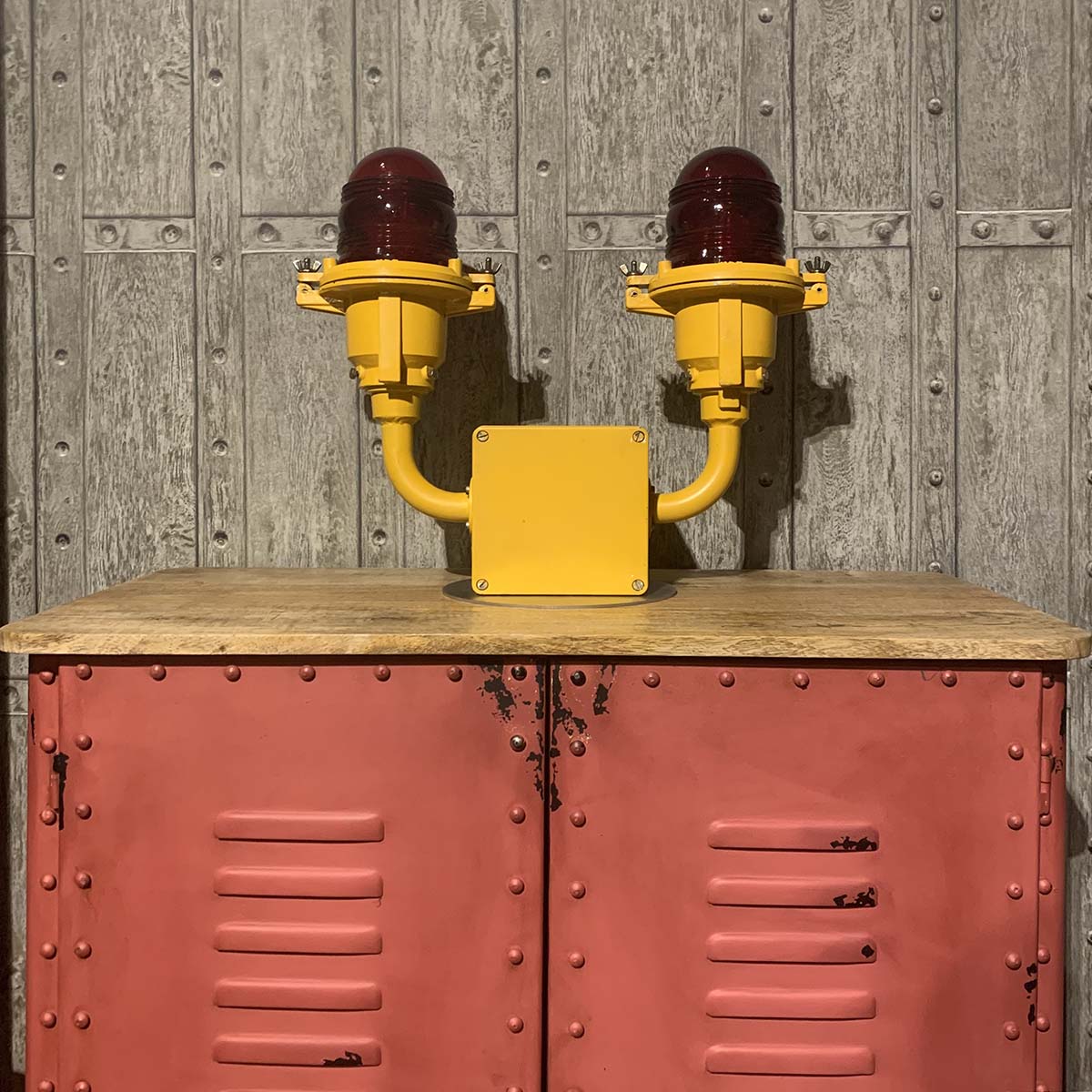 Former Berlin airport AEG airport obstruction light positioned on a pink coloured cabinet.