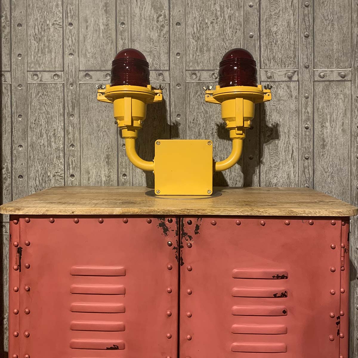 Former Berlin airport AEG airport obstruction light positioned on a pink coloured cabinet.