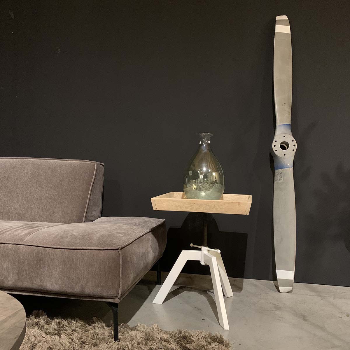 Two-bladed Sensenich propeller standing in a living room.