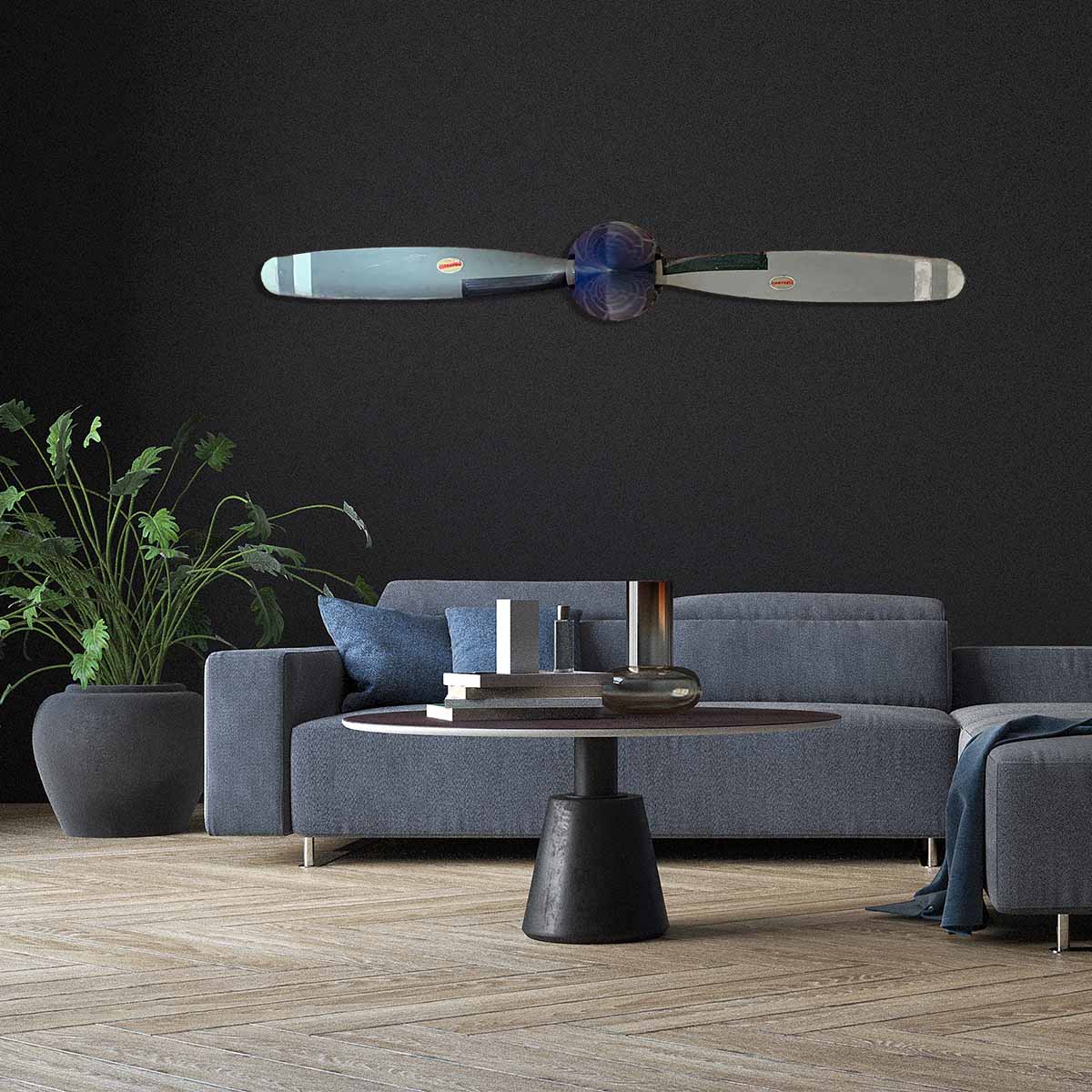 Two-bladed Hartzell propeller with spinner in original colours, mounted on a wall in a modern living room.