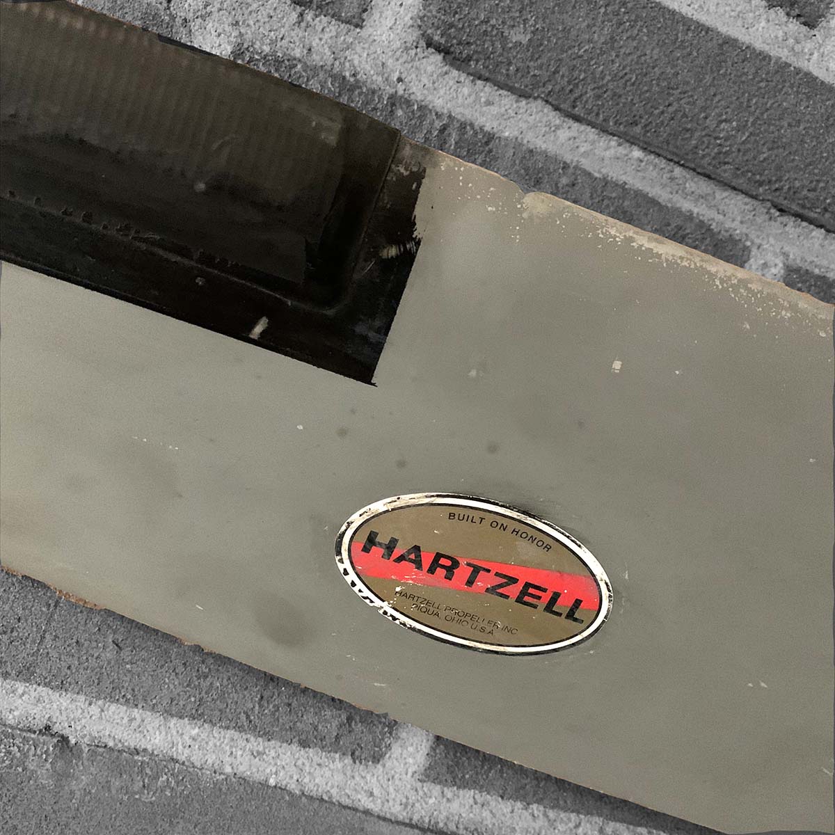 Photo of the Hartzell sticker on a propeller blade that has been modified to a decorative wall hanger.