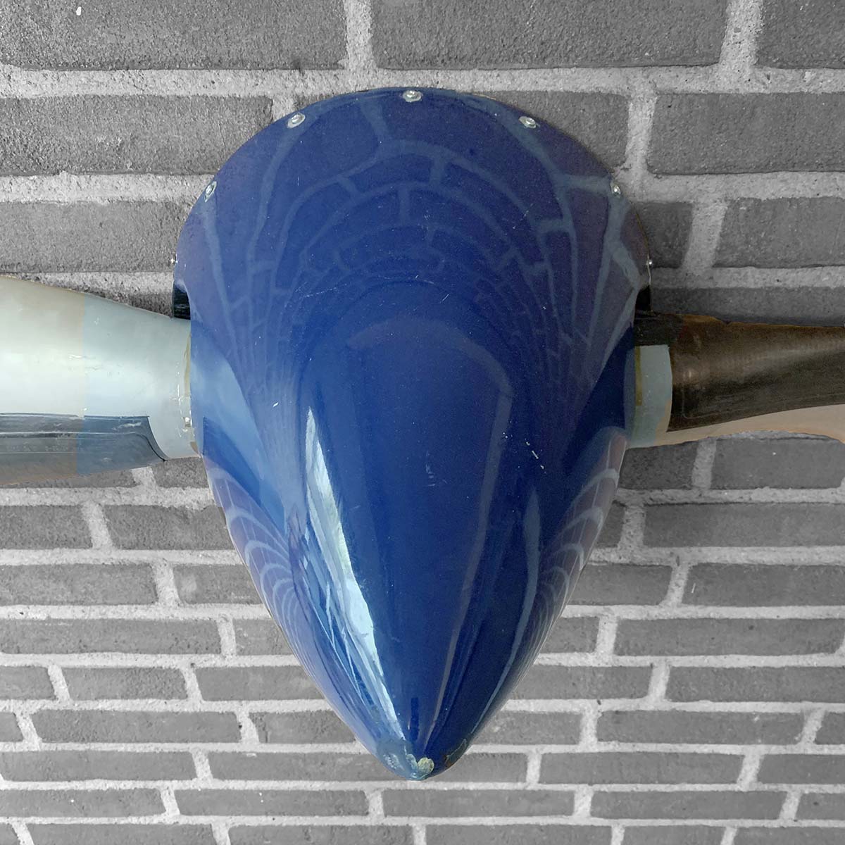 Detail of the spinner of a two-bladed Hartzell propeller that is available as a decorative wall hanger.