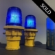 Two blue taxiway lights on a cabinet.