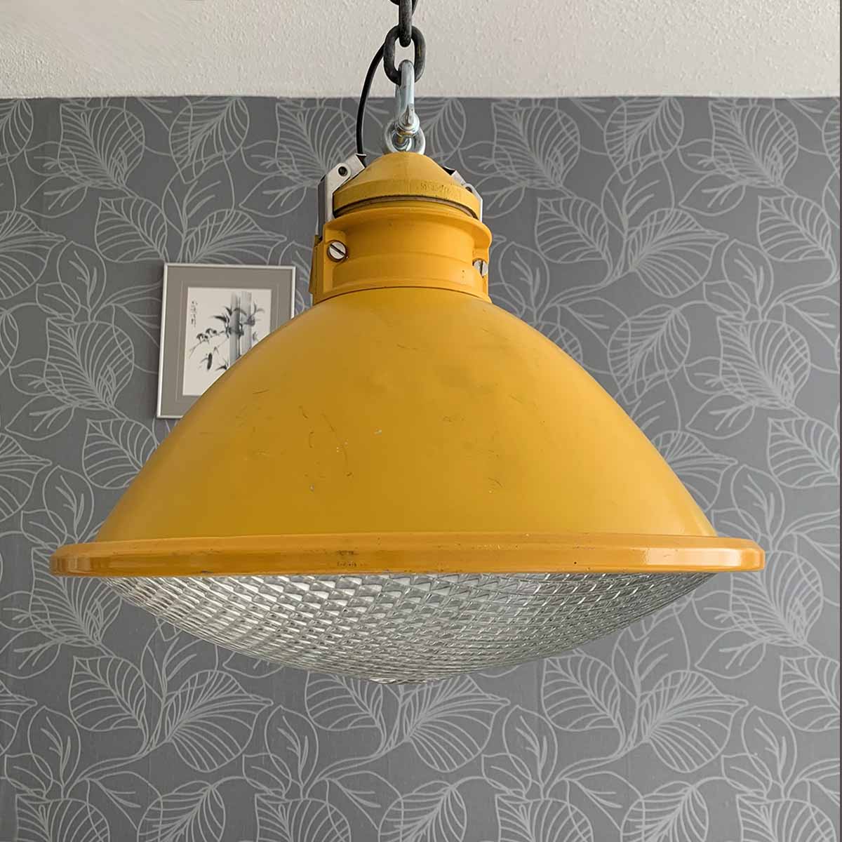 Large yellow runway light in use as a ceiling light.