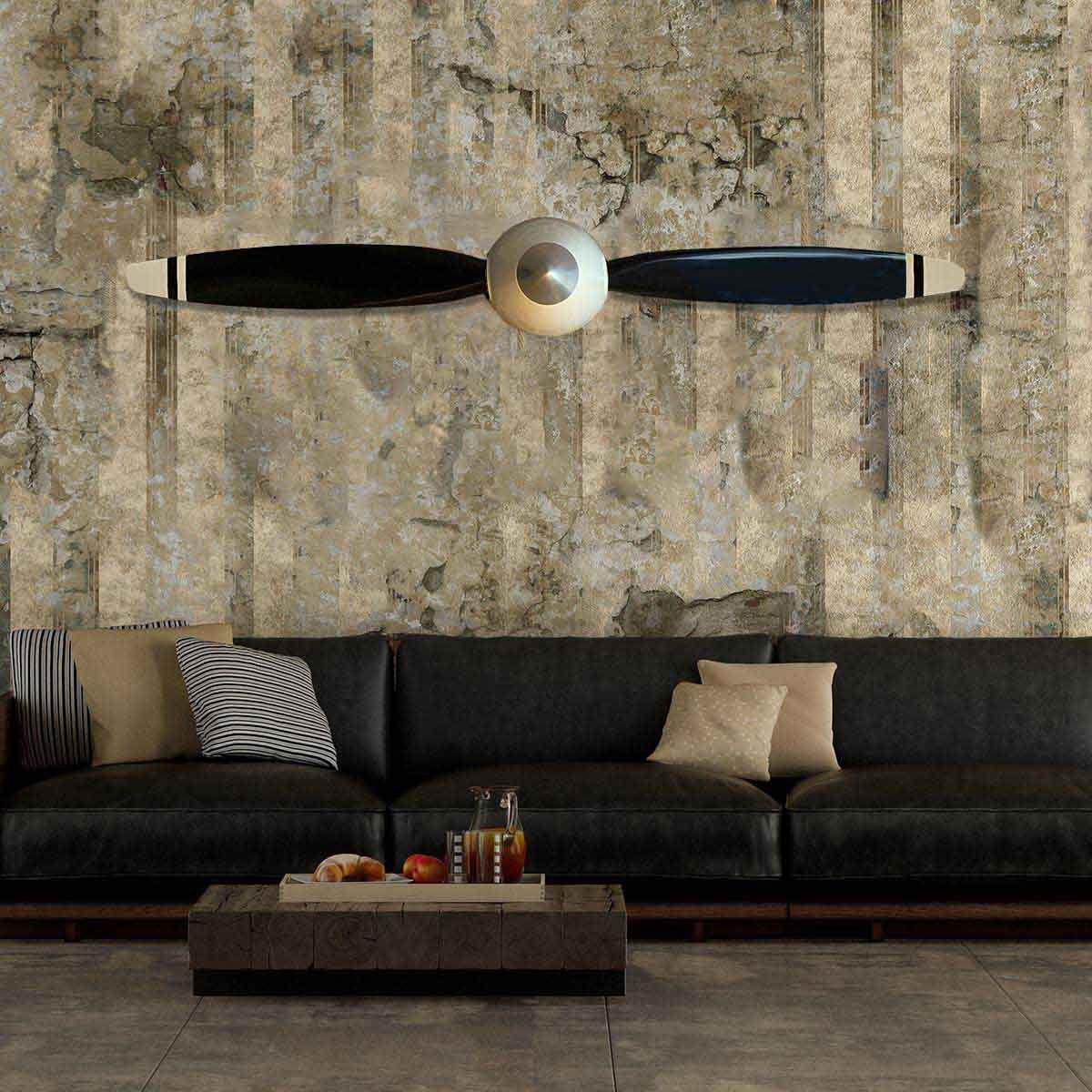 Two-bladed McCauley propeller with spinner in original colours, mounted on a wall in a modern living room.