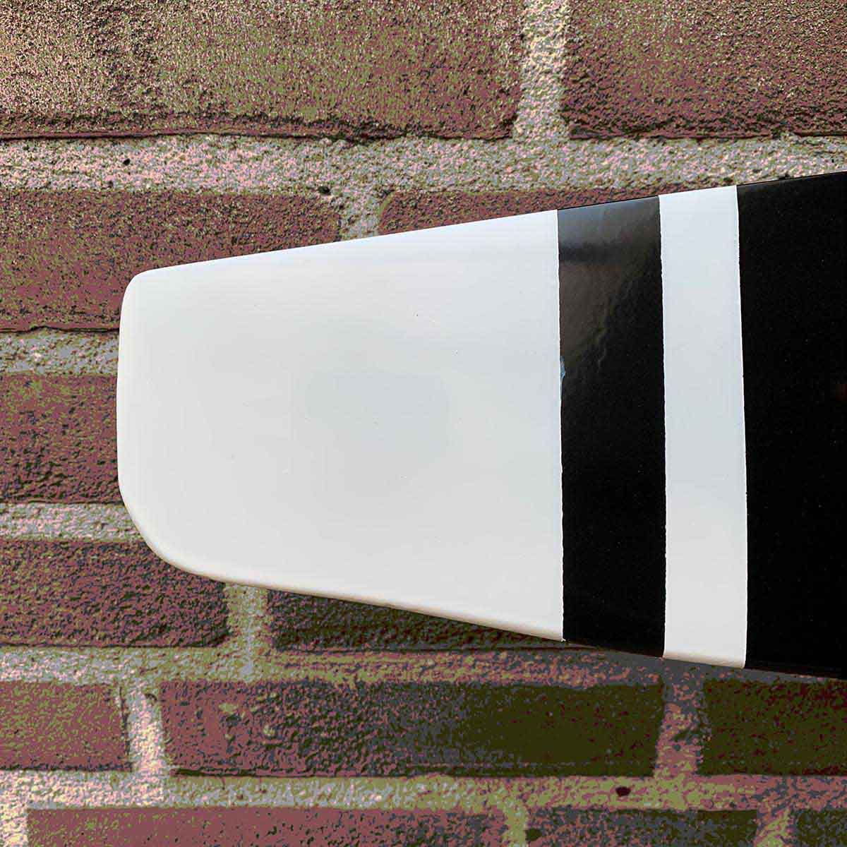 Detail of the tip of a two-bladed McCauley propeller that is available as a decorative wall hanger.