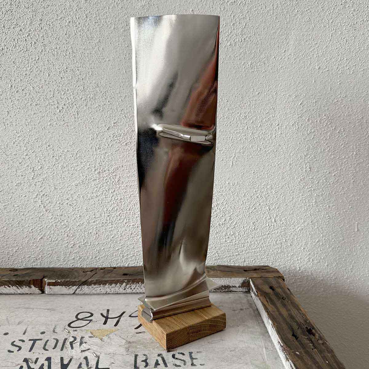Pratt & Whitney JT8D fan blade, installed on an oak base and chrome-plated.